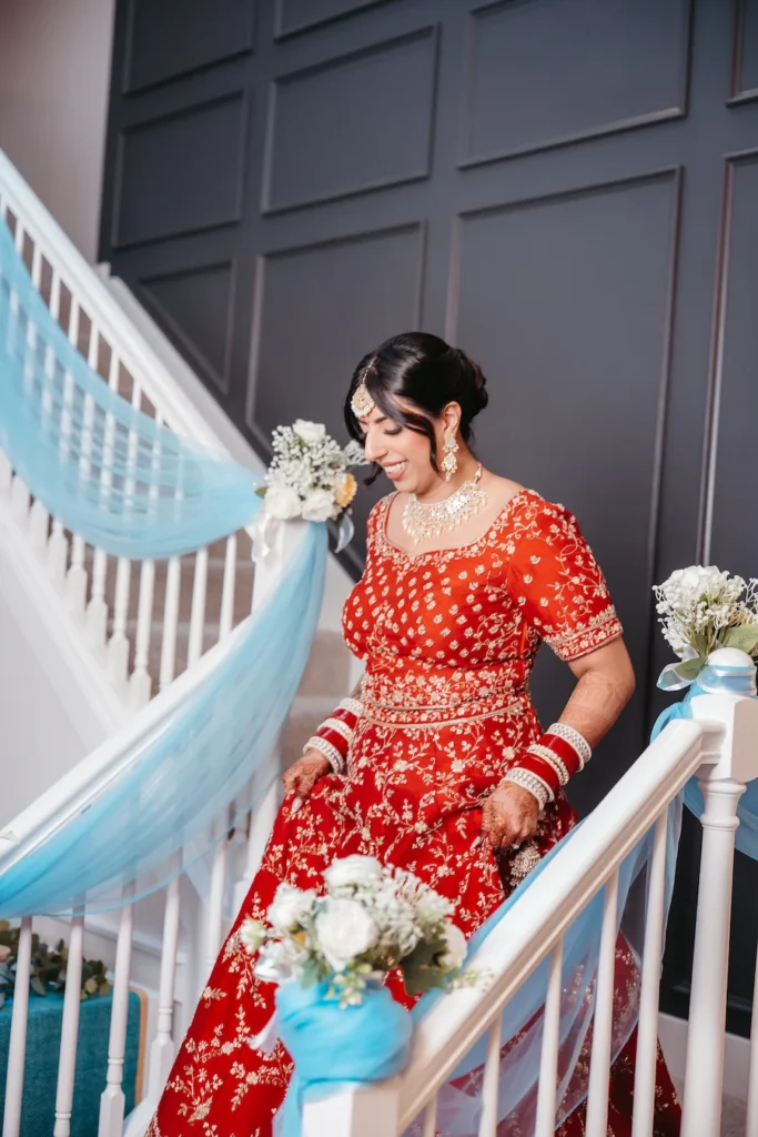 Punjabi wedding in Rishikesh bridal portrait featuring a bride in a red lehenga preparing for the ceremony