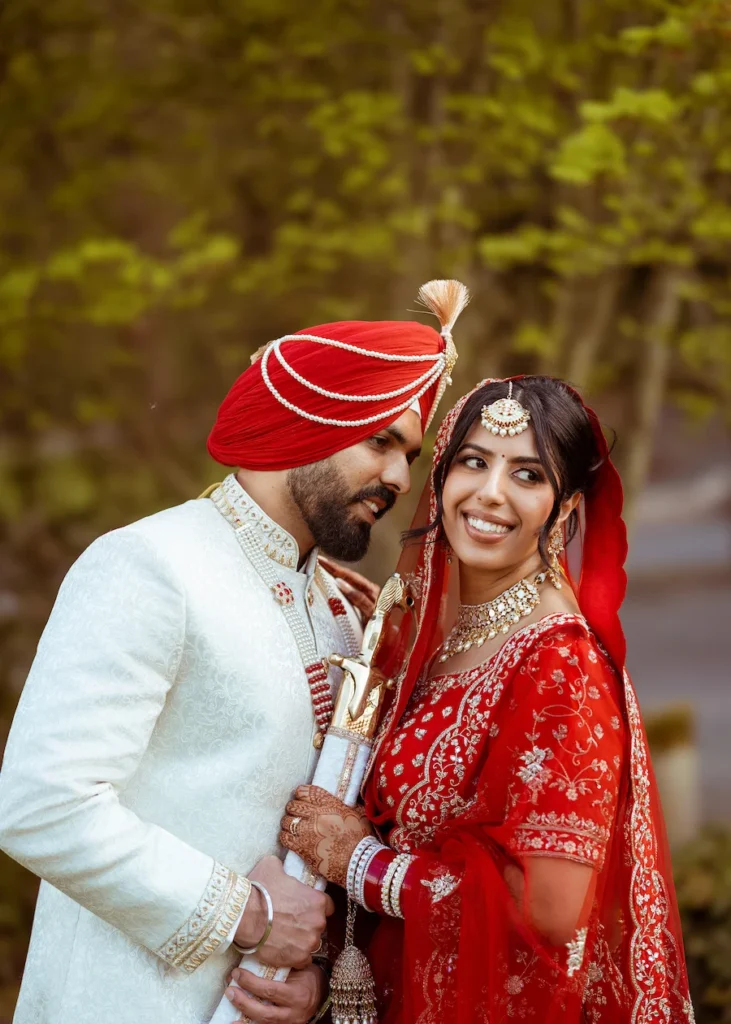 Punjabi wedding in Rishikesh bridal portrait under a red dupatta with elegant floral wedding decor