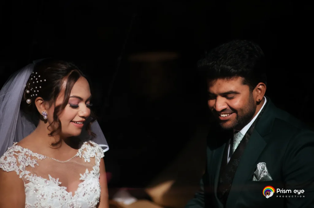 Bride and groom sharing a joyful candid moment during the wedding reception