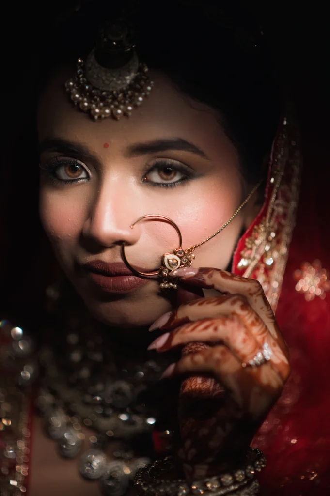 Close-up bridal portrait highlighting traditional bridal jewelry and nose ring