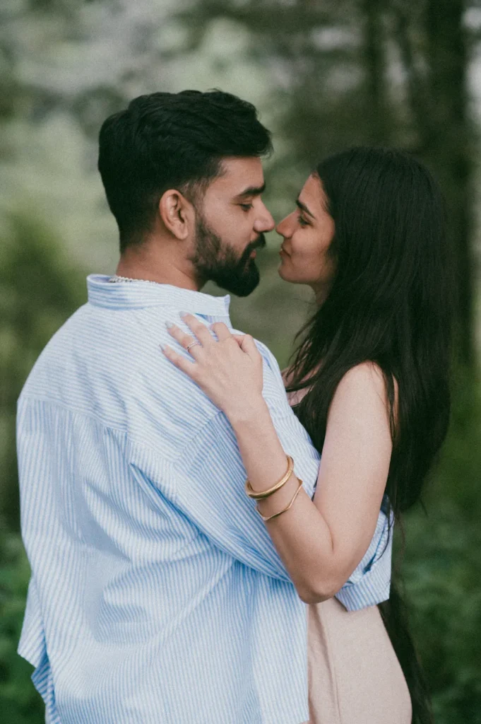 Romantic couple sharing an intimate moment during a Pre Wedding Shoot in Mussoorie surrounded by lush greenery
