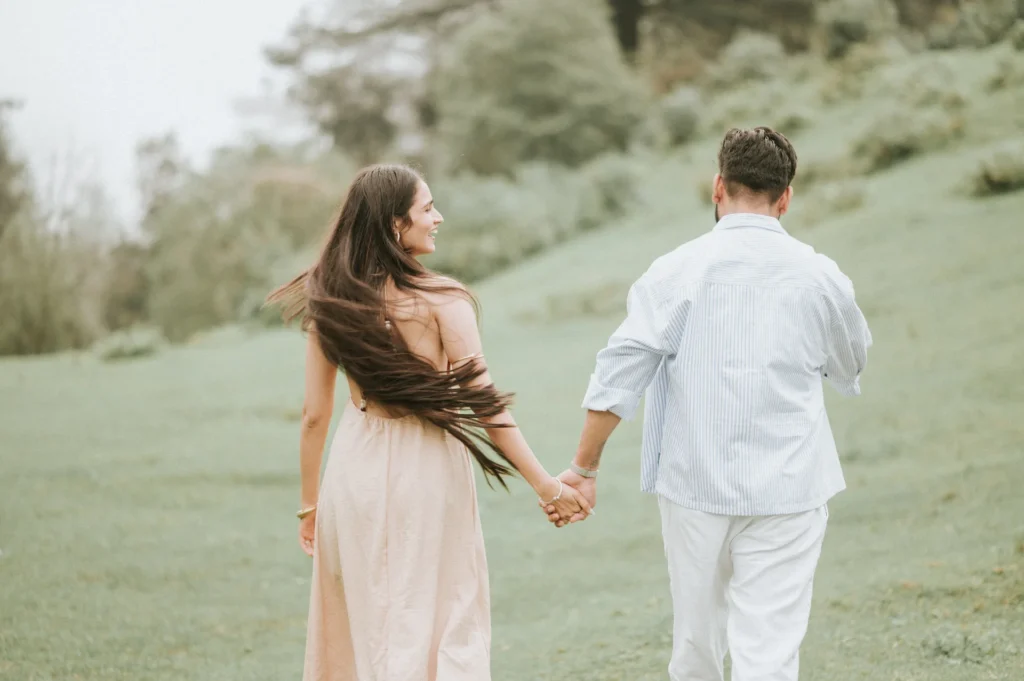 Playful couple holding hands during a Pre Wedding Shoot in Mussoorie surrounded by scenic natural beauty