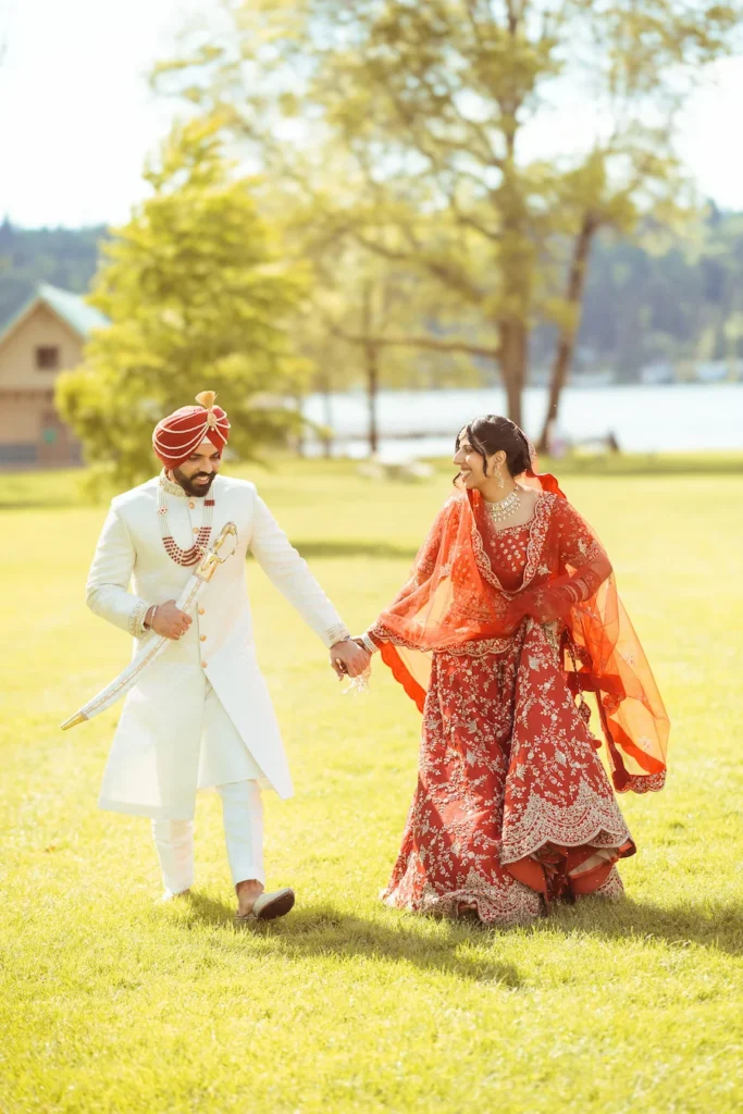 Punjabi wedding in Rishikesh couple walking hand in hand in traditional Sikh wedding attire at a scenic outdoor venue