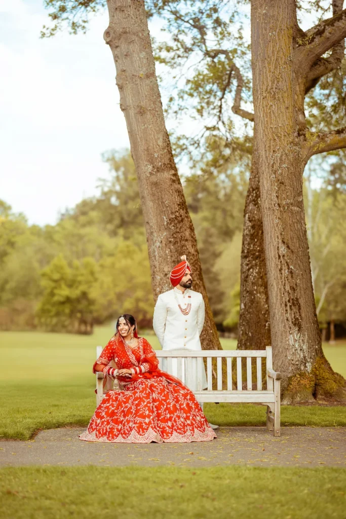 Punjabi wedding in Rishikesh bride seated on a garden bench with groom in a scenic destination wedding setting