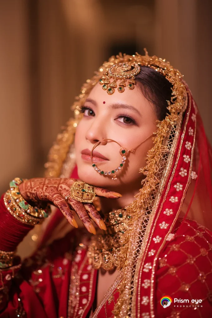 Classic bridal portrait featuring traditional Indian jewelry and graceful wedding attire.