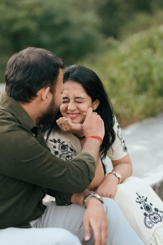 Candid pre wedding photography in Dehradun showcasing a joyful couple sharing a playful and natural moment outdoors.