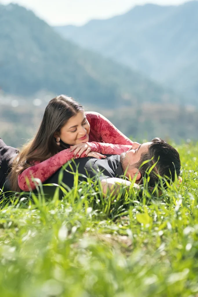 Couple enjoying a scenic meadow during a pre-wedding shoot in Uttarakhand