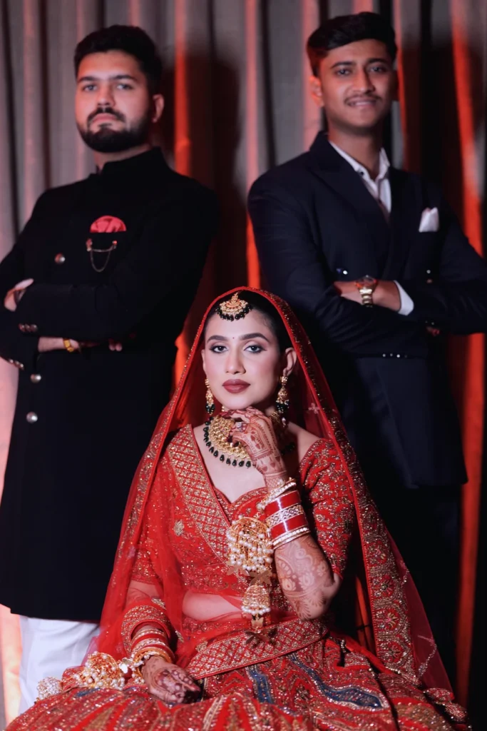 Bride posing with her brothers during a memorable family portrait at the wedding celebration.