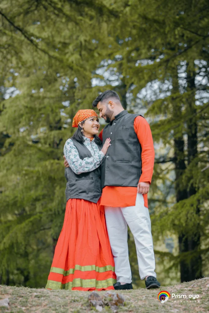 Traditional Pahadi Pre-Wedding couple wearing authentic Garhwali attire in a scenic Dehradun forest setting