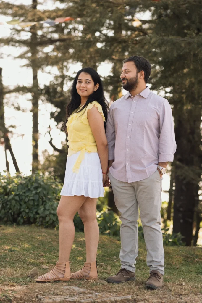 Professional Pre Wedding Photographer in Dehradun capturing a relaxed couple portrait in a scenic pine forest setting.