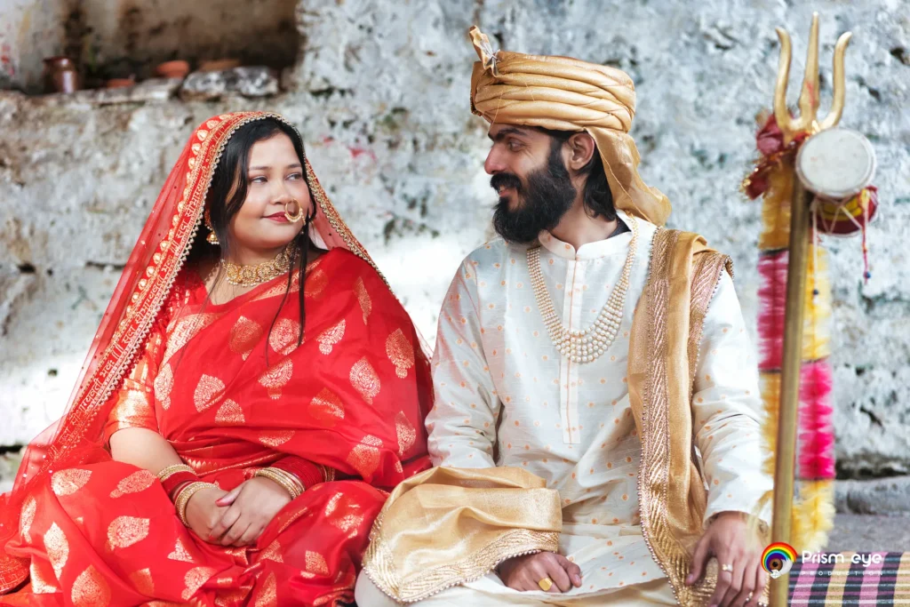 Newly married couple sharing a joyful moment during a traditional Hindu wedding.