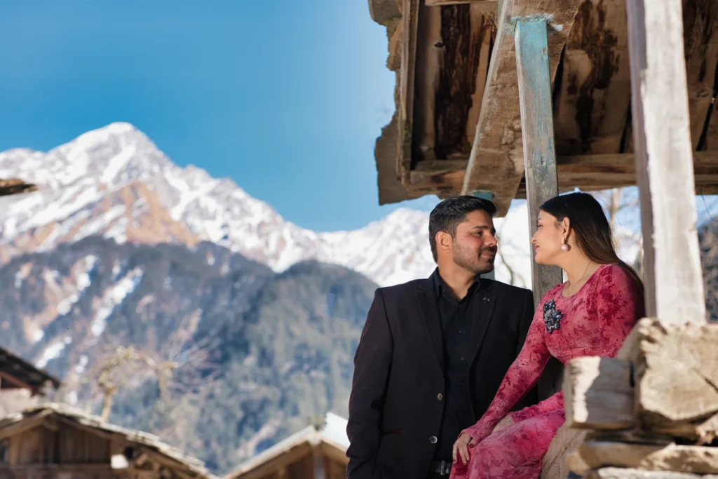 Couple posing during a heritage village pre-wedding shoot in Uttarakhand with Himalayan mountain views