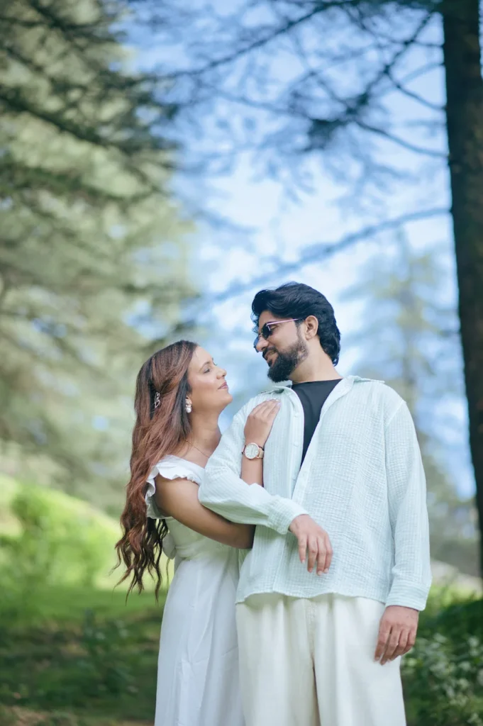 Couple sharing a romantic moment while embracing in a scenic garden.