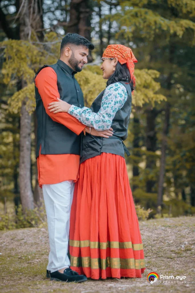 Traditional Pahadi Pre-Wedding couple wearing traditional Garhwali outfits in a scenic mountain forest