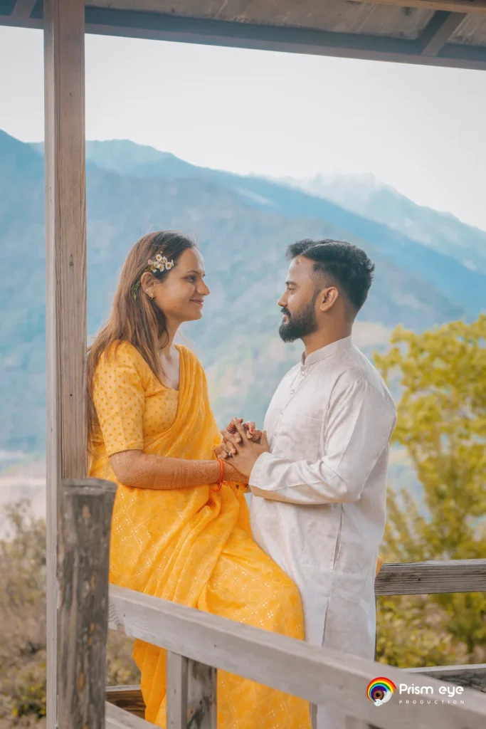 Traditional Pahadi Pre-Wedding couple holding hands against a scenic mountain backdrop in Uttarakhand