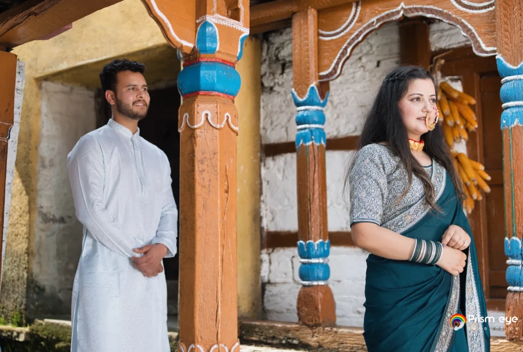 Couple posing in traditional attire inside a heritage pahadi house during a Traditional Pahadi Pre-Wedding shoot in Uttarakhand