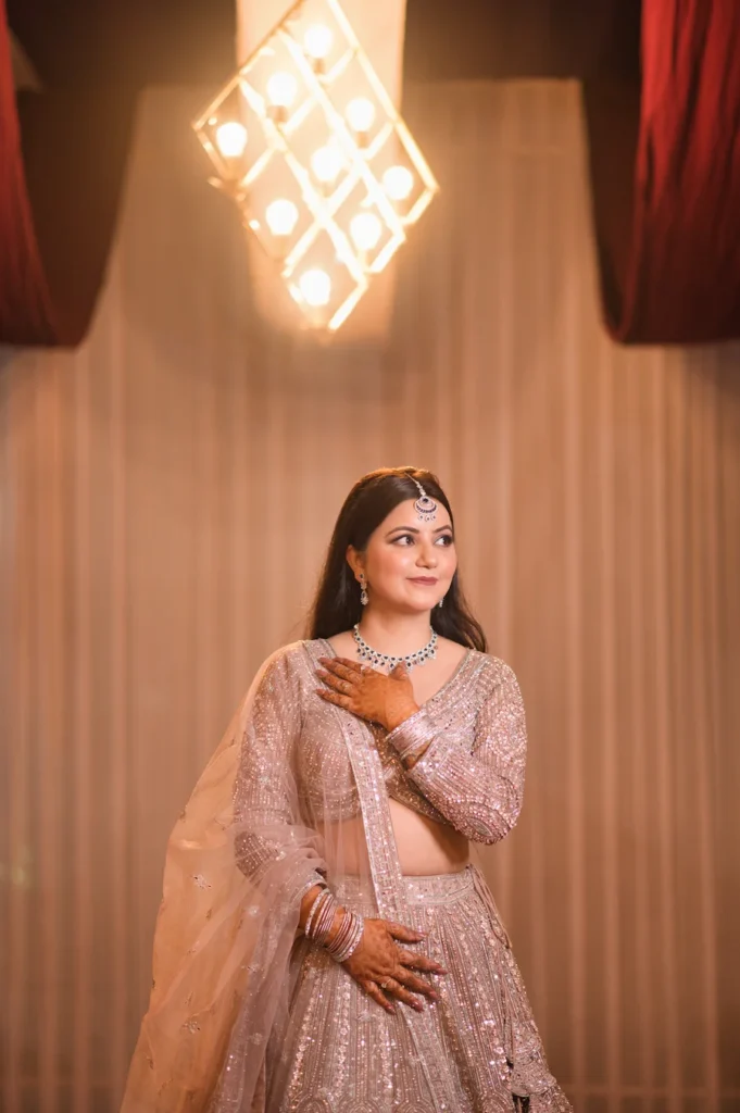 Elegant portrait of a bride in a pastel pink lehenga with graceful wedding styling