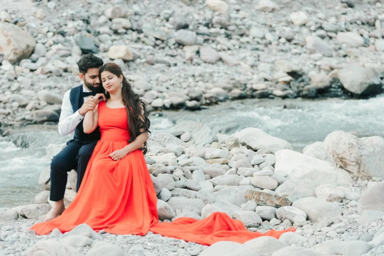 Professional Pre Wedding Photographer in Dehradun capturing a romantic couple portrait beside a scenic riverside location in Uttarakhand.