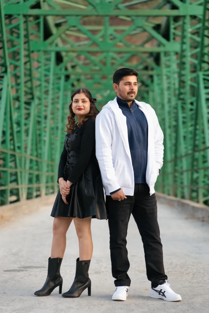 Couple posing on a heritage bridge surrounded by Himalayan landscapes