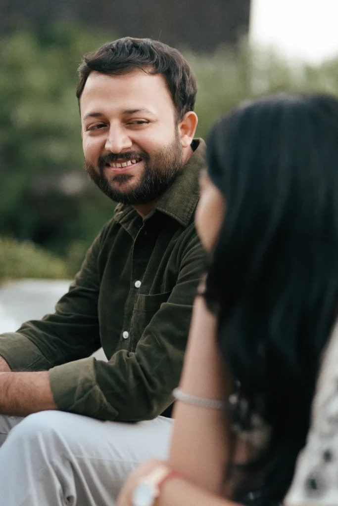 Candid pre wedding photography featuring a groom smiling during an outdoor couple shoot in Dehradun.