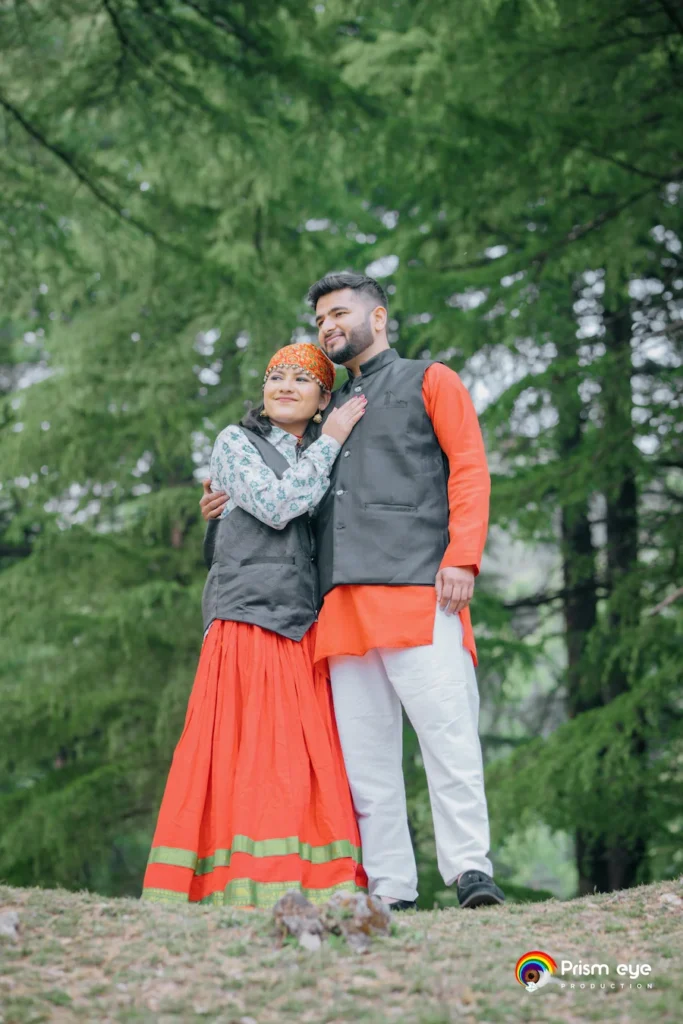 Traditional Pahadi Pre-Wedding photography featuring a couple in traditional attire amidst pine trees