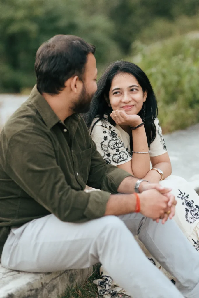Natural pre wedding photography in Dehradun featuring a couple sharing smiles and genuine emotions outdoors.