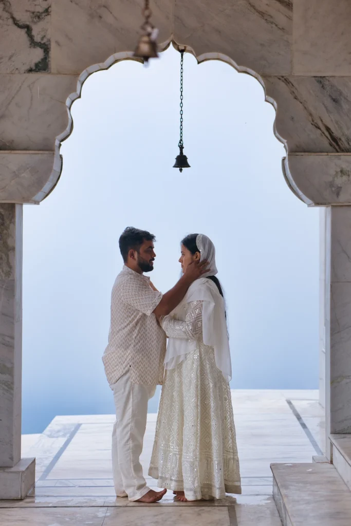 Traditional Pahadi Pre-Wedding photography featuring temple bells and mountain scenery in Uttarakhand