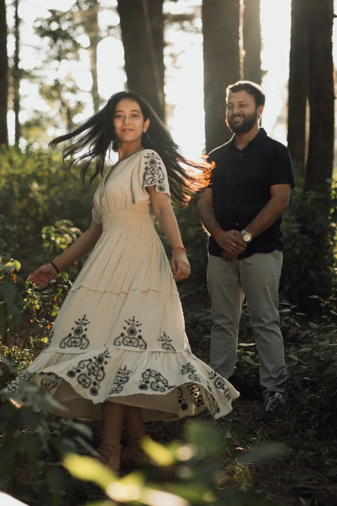 Professional Pre Wedding Photographer in Dehradun capturing a candid twirling portrait of a bride-to-be during a golden hour forest photoshoot in Uttarakhand.