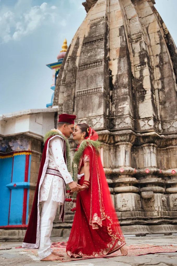 Couple portrait during a traditional Ukhimath wedding ceremony at Omkareshwar Temple, showcasing the spiritual charm and heritage of Uttarakhand.