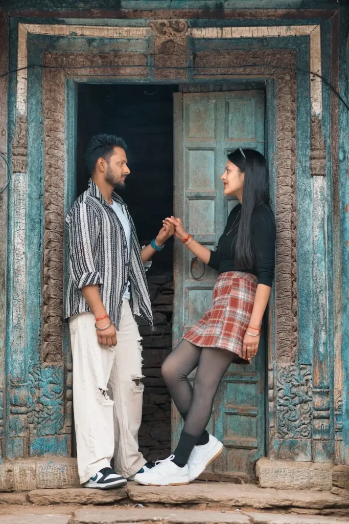 Destination Weddings featuring a couple at a traditional Himalayan village doorway in Uttarakhand