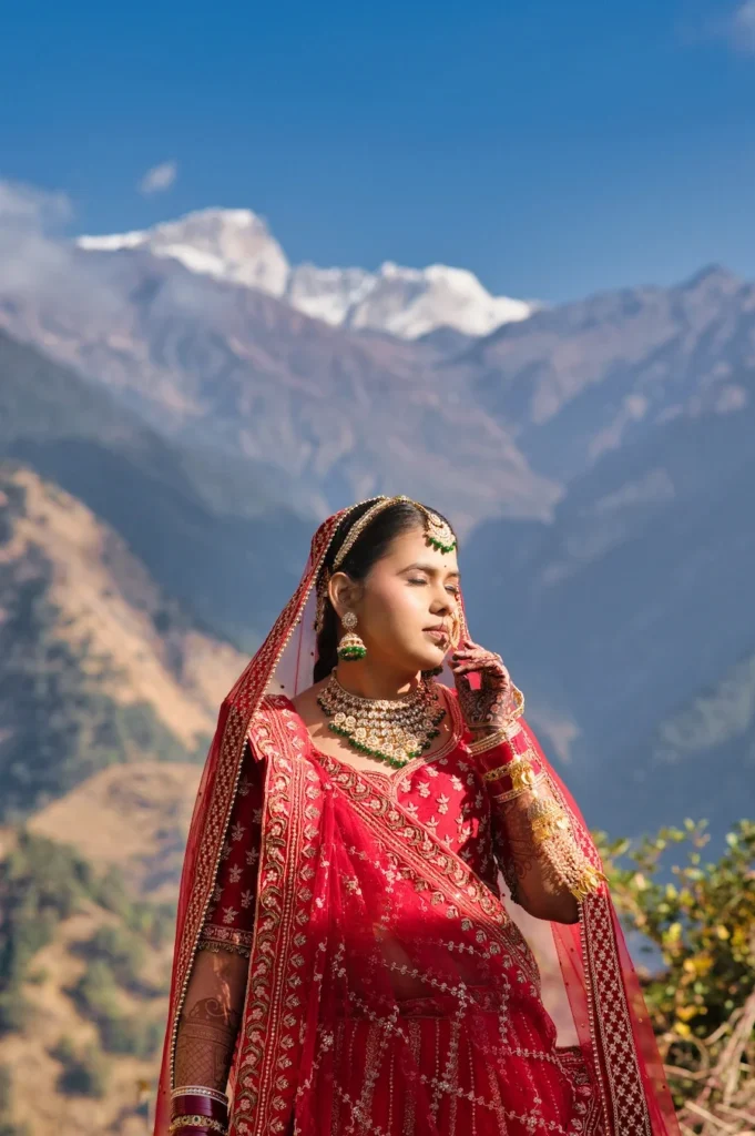 Wedding bride portrait with the Himalayan mountains in the background during a traditional Uttarakhand wedding ceremony.