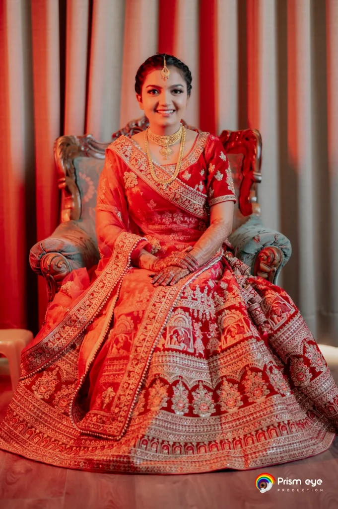 Traditional bridal portrait with red lehenga and classic wedding styling