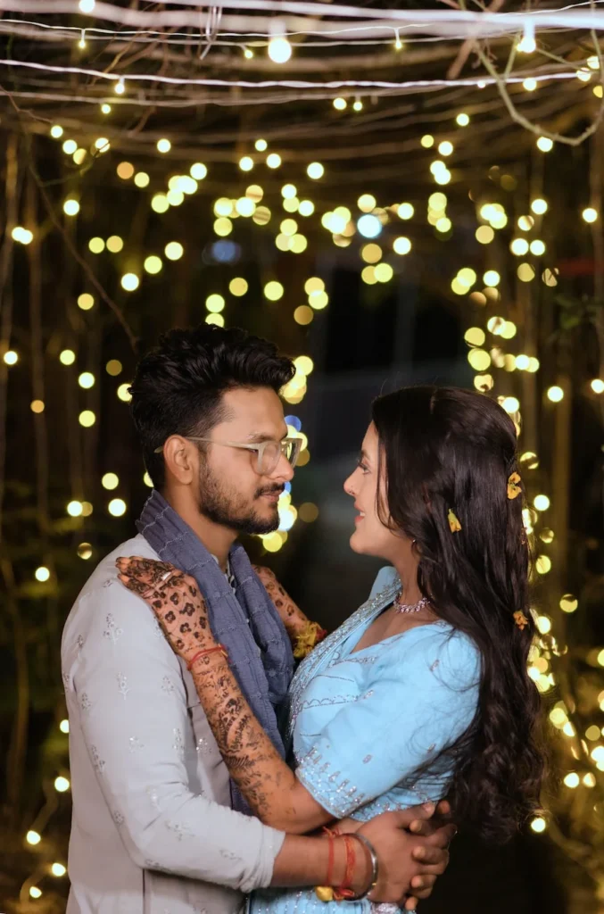 Evening couple portrait with decorative lights during Destination Weddings celebrations