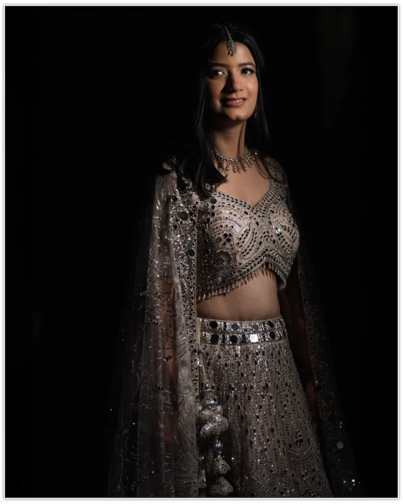 Bride posing in a dramatic portrait illuminated with soft directional lighting.