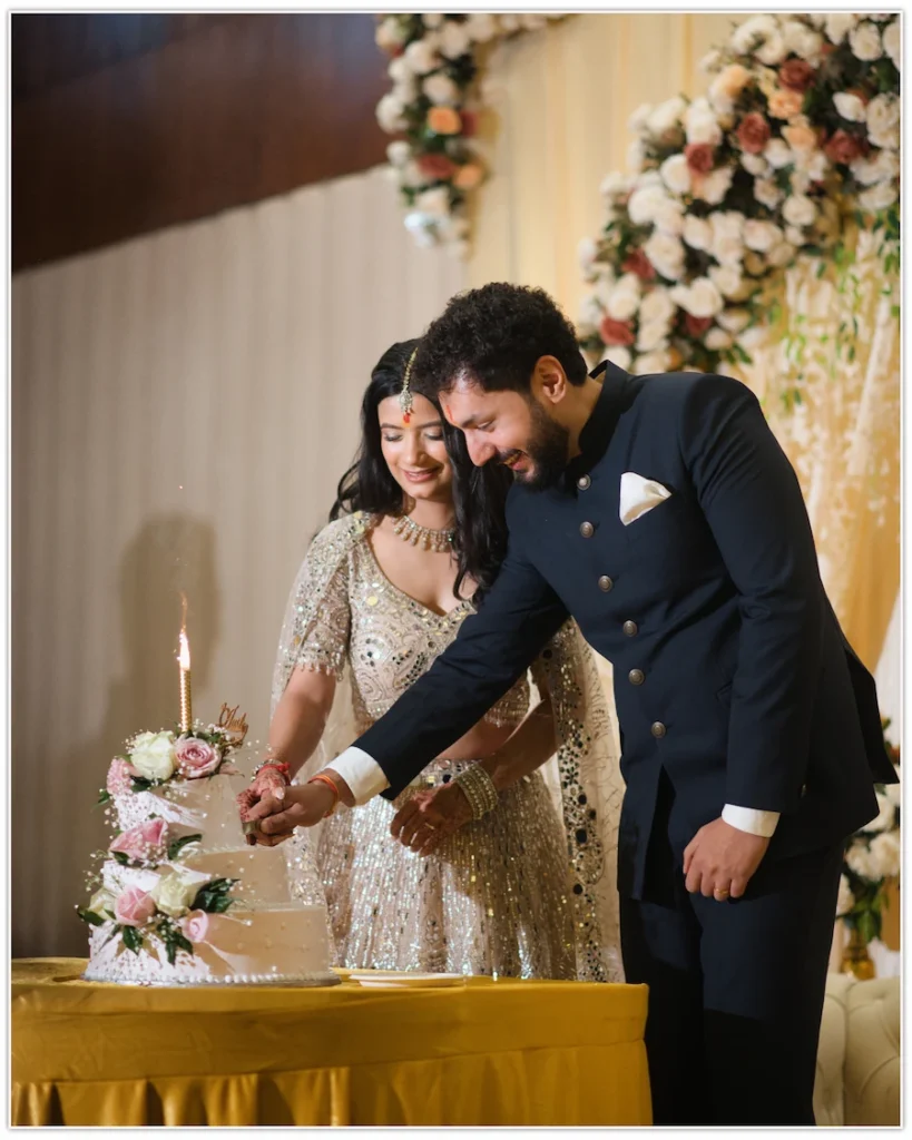 Couple cutting their engagement cake while celebrating with smiles during the ceremony.