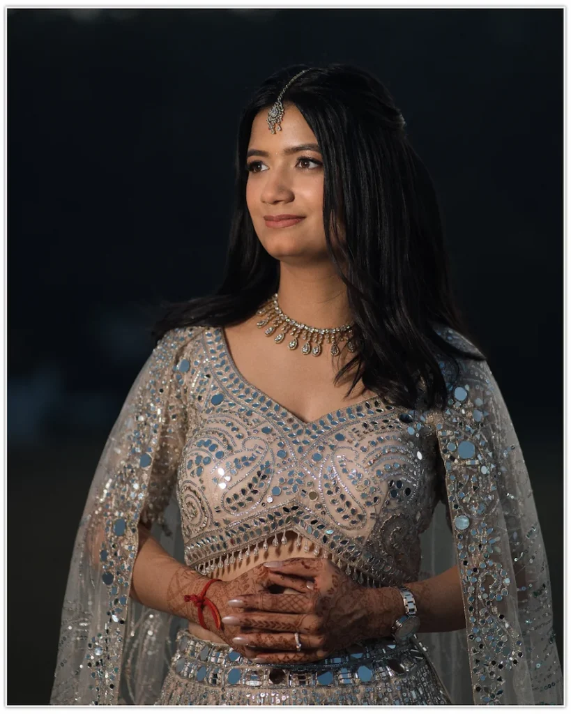 Elegant bridal portrait highlighting traditional jewellery and embroidered lehenga.