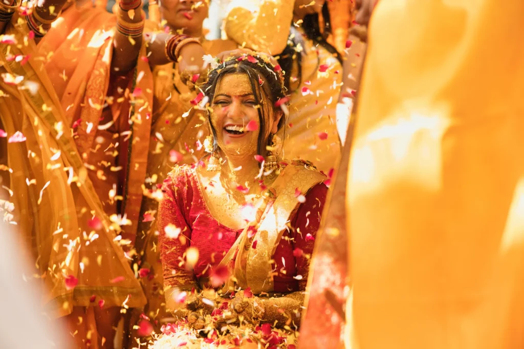 Couple portrait during a colorful mehndi celebration with floral jewellery