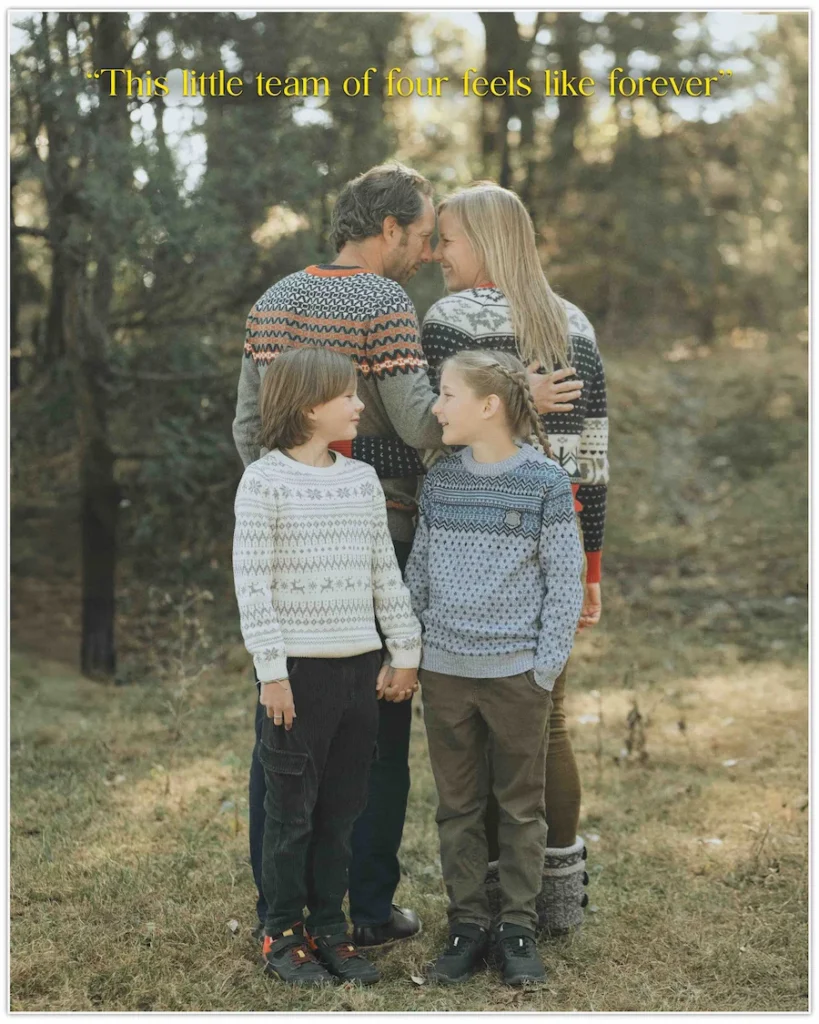 Parents embracing as their children stand together in a peaceful forest, capturing a heartfelt family moment.