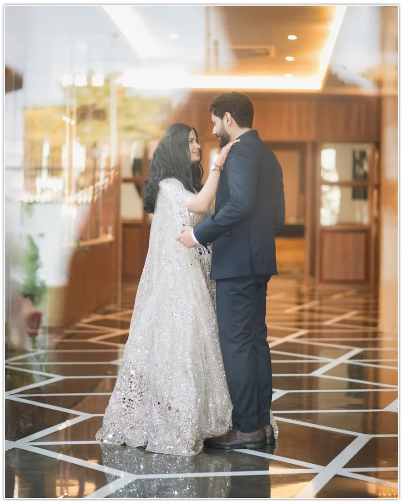 Couple embracing in a luxurious indoor venue during a romantic engagement photoshoot.
