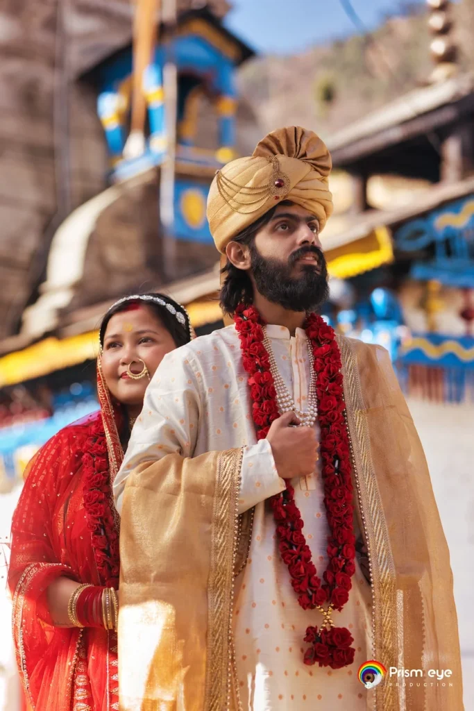 Groom leading the bride through the temple courtyard after the marriage ceremony.