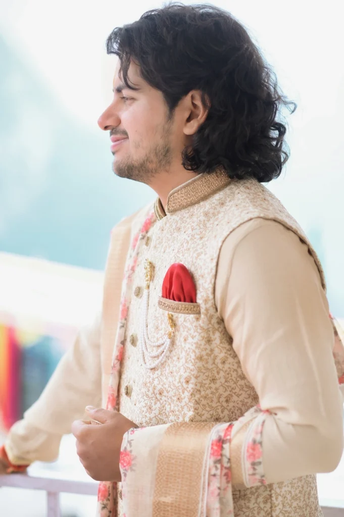 Portrait of the groom in traditional wedding attire overlooking the Himalayan landscape.