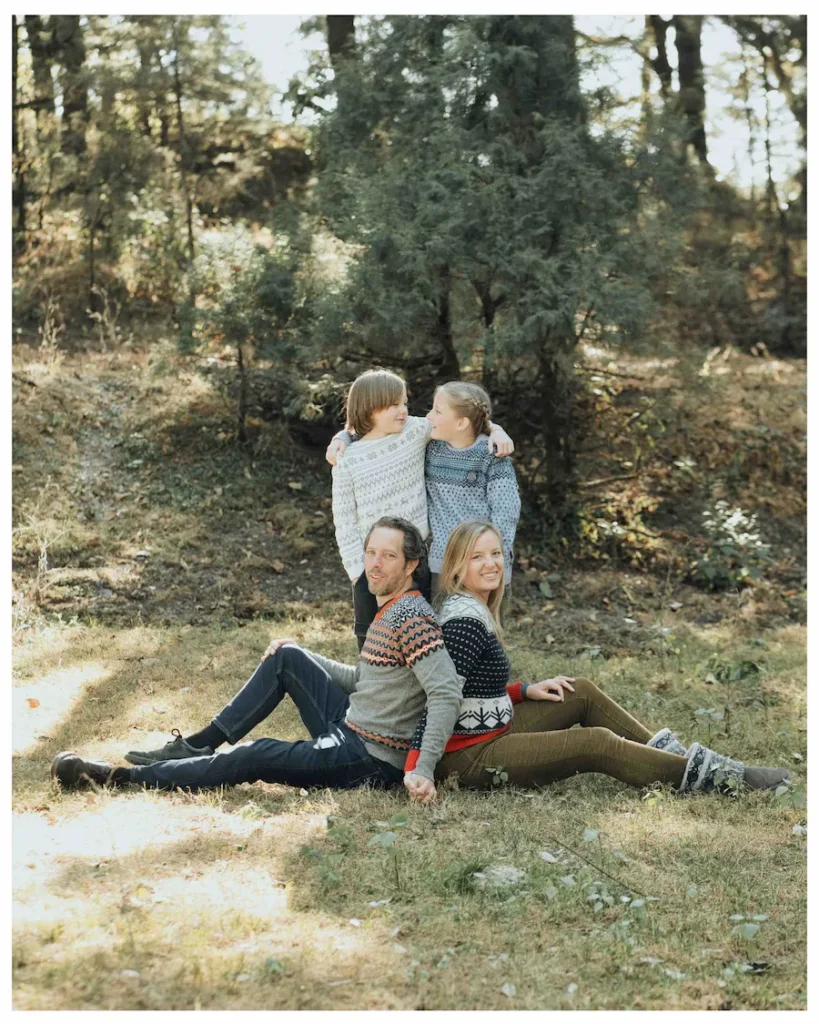 Parents and children relaxing together in a peaceful forest surrounded by the natural beauty of Mussoorie.