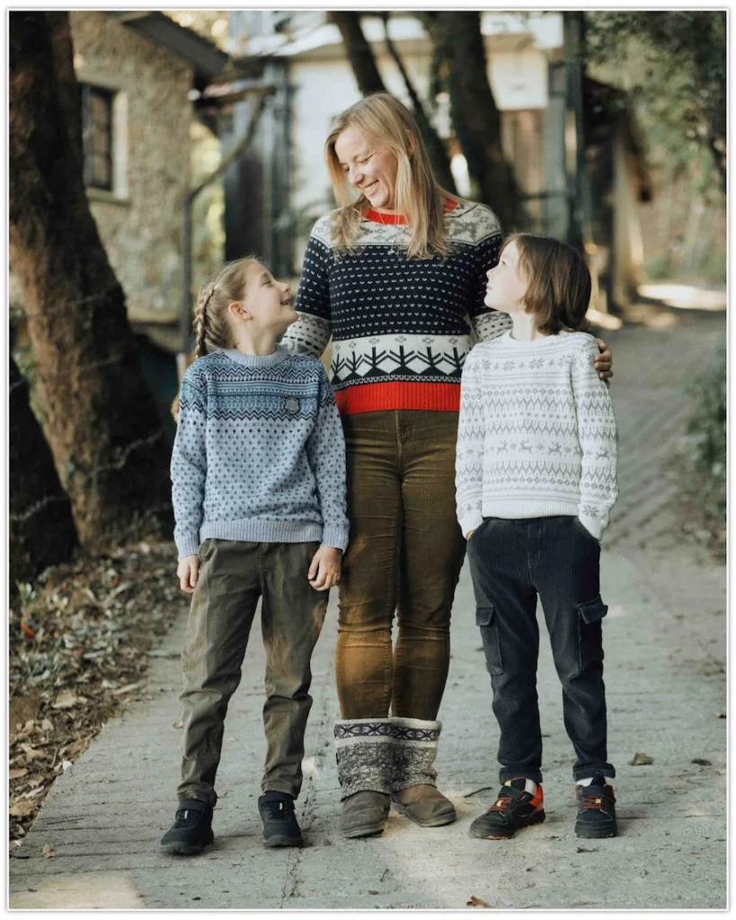 Mother walking with her children along a tree-lined pathway, sharing smiles and genuine moments in Mussoorie.
