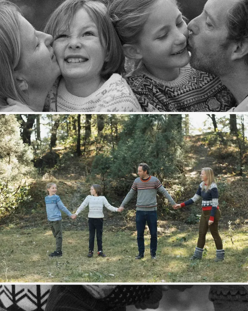 Parents affectionately kissing their children while capturing genuine laughter and happy memories outdoors.