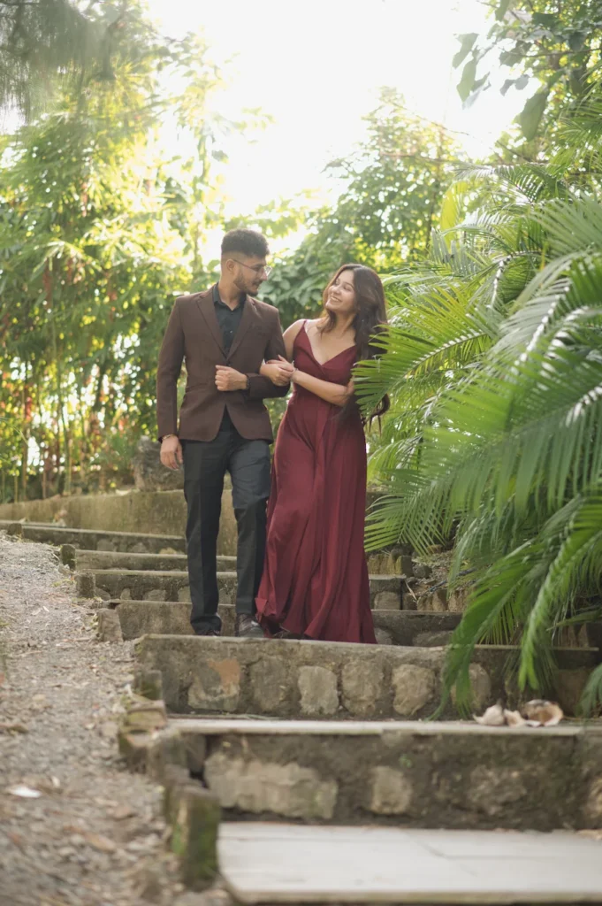 Elegant couple walking through lush greenery during the best time for pre-wedding shoot in Dehradun