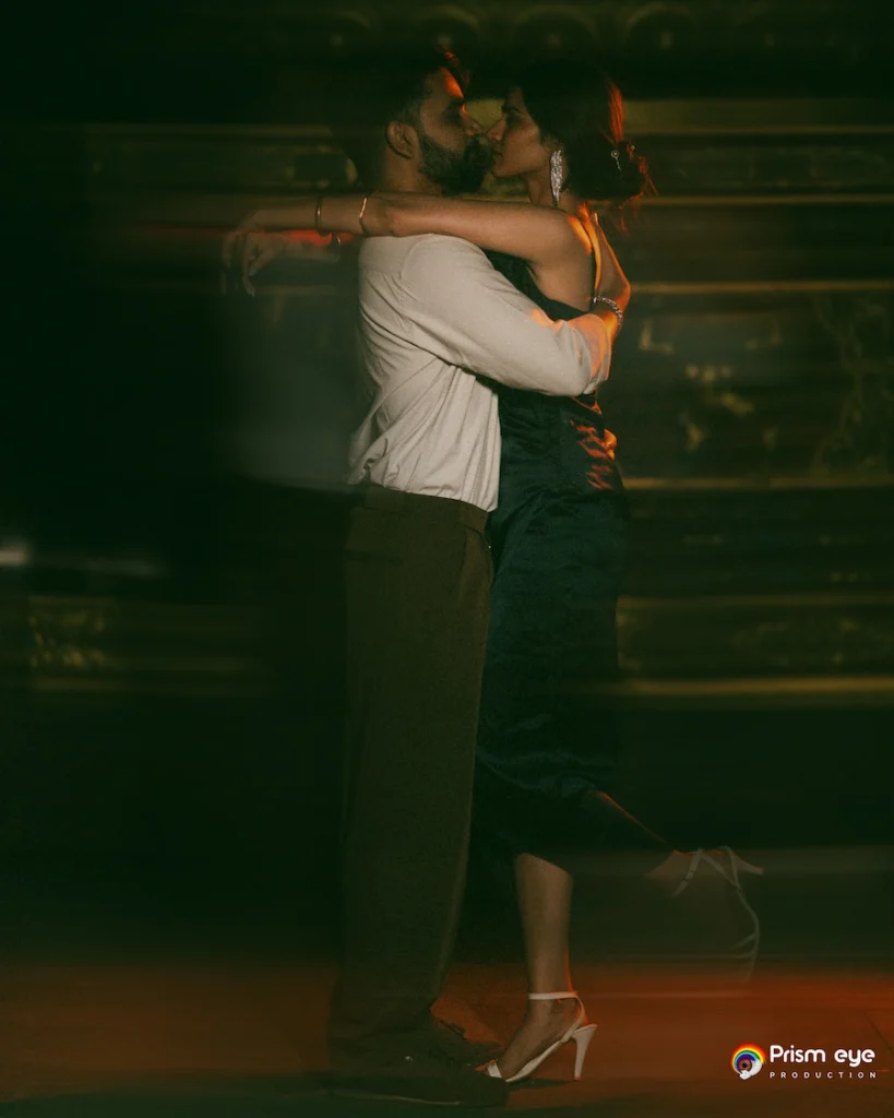 Romantic night portrait of a couple embracing under dramatic lighting during an intimate pre wedding session.
