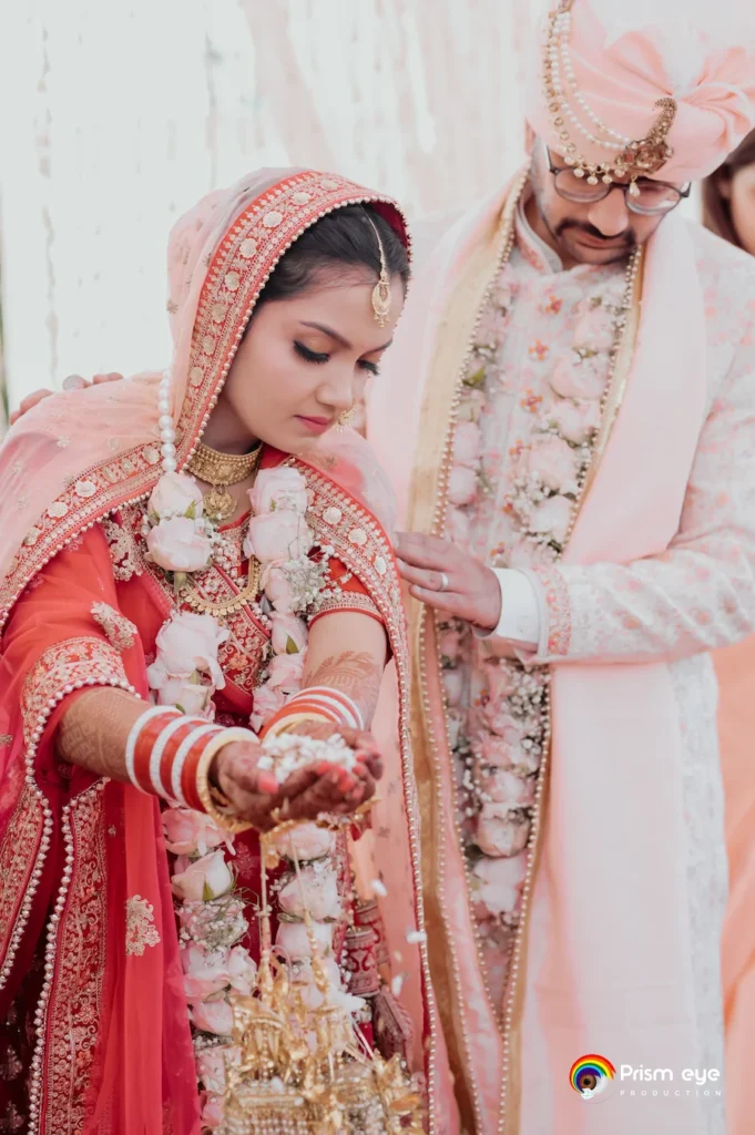Bride and groom performing sacred wedding rituals during a traditional Hindu marriage ceremony