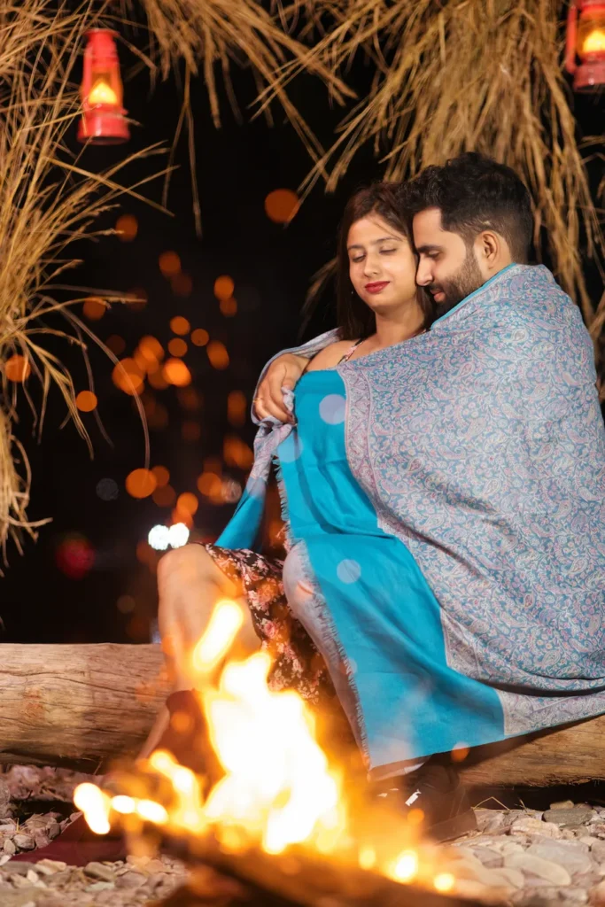 Couple enjoying a romantic bonfire during a Pre-Wedding Shoot in Rishikesh by the riverside