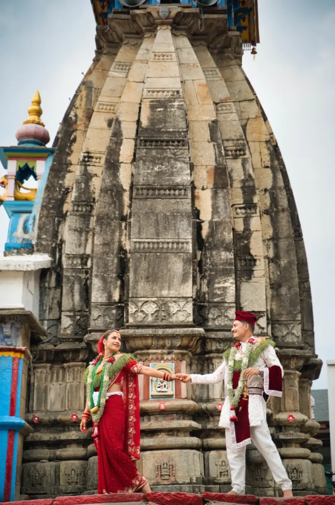 Couple posing at a historic temple wedding venue among the top Destination Wedding Locations in Uttarakhand