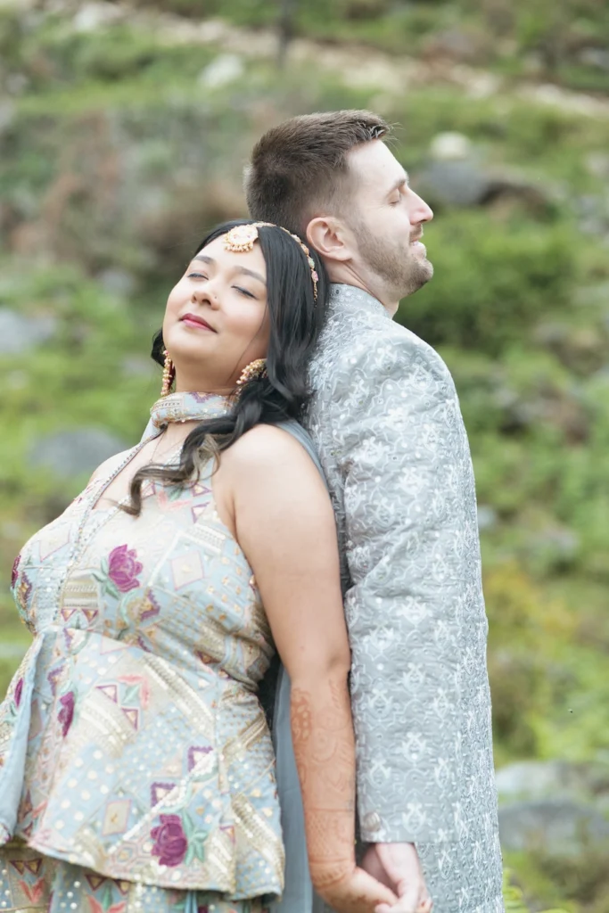 Couple sharing a romantic moment during an outdoor portrait session surrounded by nature